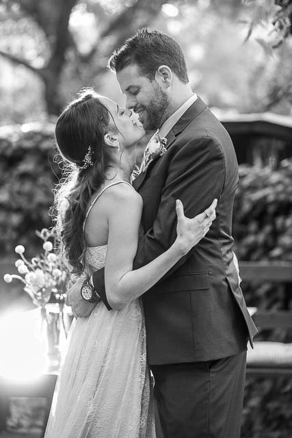 Newlyweds taking romantic sunset photos during their Ojai The Ranch House wedding reception.