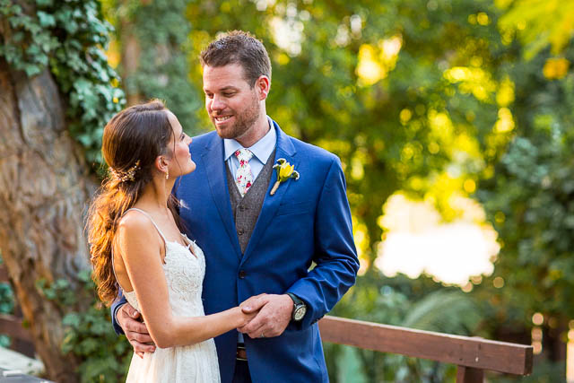 Newlyweds taking romantic sunset photos during their Ojai The Ranch House wedding reception.