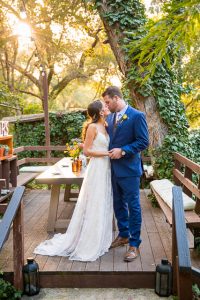 Newlyweds taking romantic sunset photos during their Ojai The Ranch House wedding reception.