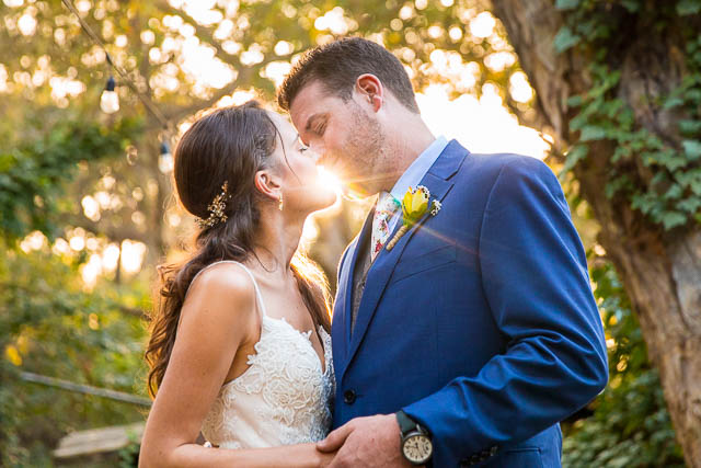 Newlyweds taking romantic sunset photos during their Ojai The Ranch House wedding reception.