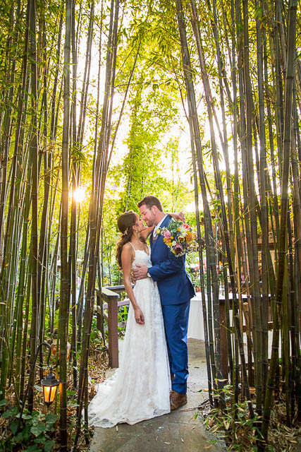 Newlyweds taking romantic sunset photos during their Ojai The Ranch House wedding reception.