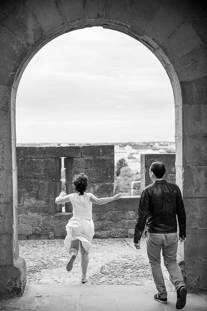 Wedding photographs of couple walking together in the Cité de Carcassonne, a medieval fortress.