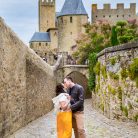 Wedding photographs of couple walking together in the Cité de Carcassonne, a medieval fortress.