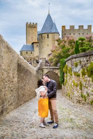 Wedding photographs of couple walking together in the Cité de Carcassonne, a medieval fortress.