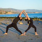 The engaged couple doing yoga poses during their yogi engagement photoshoot.