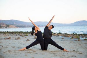 The engaged couple doing yoga poses during their yogi engagement photoshoot.