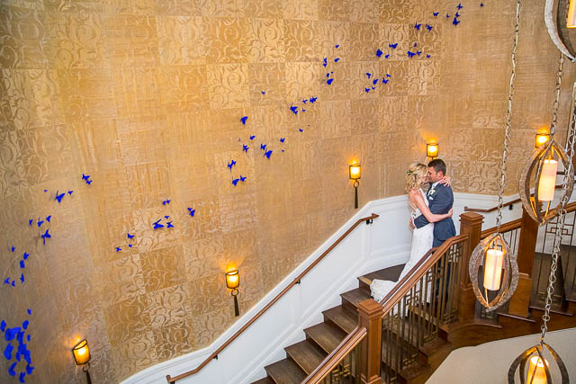 Bride and groom posing at the Butterfly Wall at their Belmond El Encanto wedding.