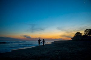 Beach sunset silhouette photos of a couple taken during their Santa Barbara beach engagement photoshoot.