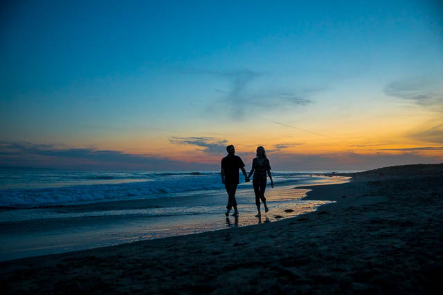 Beach sunset silhouette photos of a couple taken during their Santa Barbara beach engagement photoshoot.