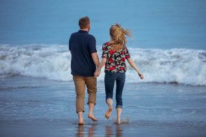 Couple having fun, being playful at their Santa Barbara engagement photoshoot.