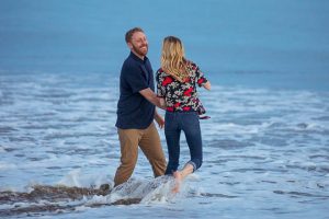Couple having fun, being playful at their Santa Barbara engagement photoshoot.