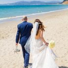 Couple walking along the beach at their Four Seasons Santa Barbara wedding.