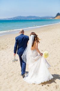 Couple walking along the beach at their Four Seasons Santa Barbara wedding.