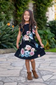 Girl twirling in dress at the Santa Barbara Courthouse.