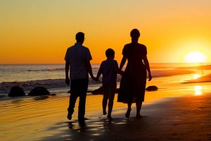 Silhouette photo of family laughing during their beach family photoshoot in Santa Barbara.