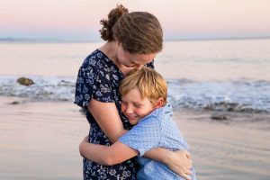 Family laughing during their beach family photoshoot in Santa Barbara.