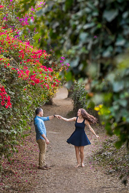 Newly engaged couple dancing romantically at their engagment photos.