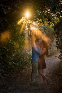 Couple basking in the golden hour sunset lighting during their engagement photoshoot.