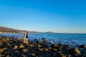 Engaged couple with a view of the ocean in Santa Barbara.