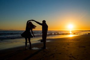 Creative sunset beach silhoutte engagement photos of couple at the beach in Santa Barbara, California.