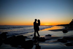 Creative engagement photography of engaged couple at the beach.
