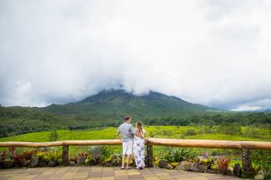 Engaged couple overlooking Arenal Volcano in La Fortuna, Costa Rica, during their La Fortuna engagment photoshoot.