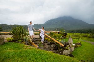 Engaged couple walking together at Arenal Volcano in La Fortuna, Costa Rica.