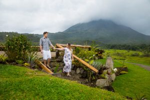 Engaged couple walking together at Arenal Volcano in La Fortuna, Costa Rica.