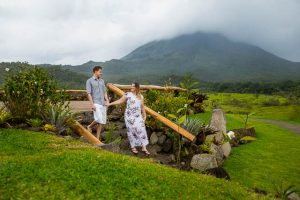 Engaged couple walking together at Arenal Volcano in La Fortuna, Costa Rica.