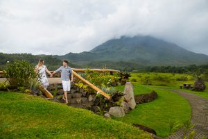 Engaged couple walking together at Arenal Volcano in La Fortuna, Costa Rica.