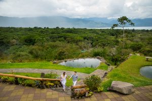 Engaged couple walking together at Arenal Volcano in La Fortuna, Costa Rica.