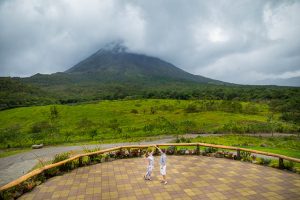 Engagement photos of bride and groom dancing in front of Arenal Volcano in La Fortuna, Costa Rica.