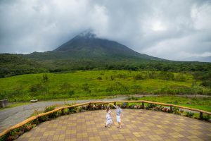 Engagement photos of bride and groom dancing in front of Arenal Volcano in La Fortuna, Costa Rica.