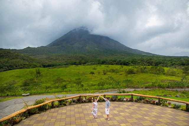 Engagement photos of bride and groom dancing in front of Arenal Volcano in La Fortuna, Costa Rica.