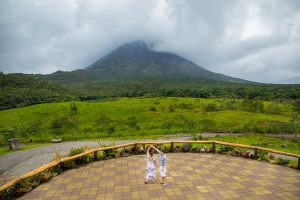 Engagement photos of bride and groom dancing in front of Arenal Volcano in La Fortuna, Costa Rica.