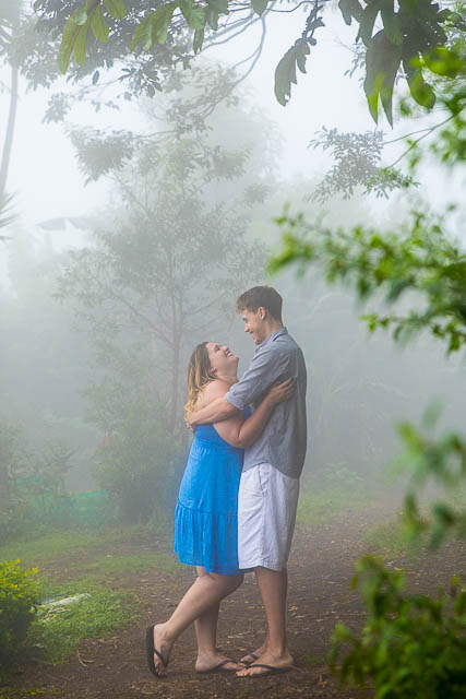 Engaged couple taking photos at their engagement photoshoot in Monteverde, Costa Rica, as the clouds roll in.