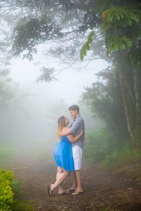Engaged couple taking photos at their engagement photoshoot in Monteverde, Costa Rica, as the clouds roll in.