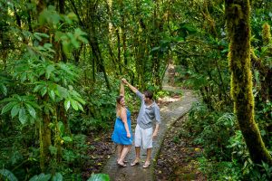 Engaged couple posing at the Selvatura Park at the raincloud forest in Monteverde, Costa Rica during their engagement photoshoot.