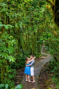 Engaged couple posing at the Selvatura Park at the raincloud forest in Monteverde, Costa Rica during their engagement photoshoot.
