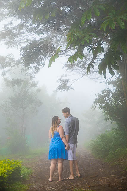 Engaged couple taking photos at their engagement photo session in Monteverde, Costa Rica, as the clouds roll in.