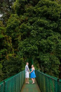 Couple walking across the hanging bridges in the rain cloud forest of Selvatura Park in Monteverde, Costa Rica.