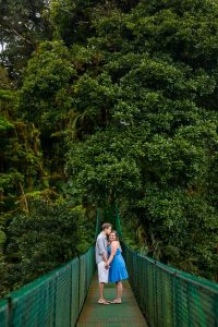 Couple walking across the hanging bridges in the rain cloud forest of Selvatura Park in Monteverde, Costa Rica.