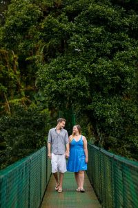 Couple walking across the hanging bridges in the rain cloud forest of Selvatura Park in Monteverde, Costa Rica.
