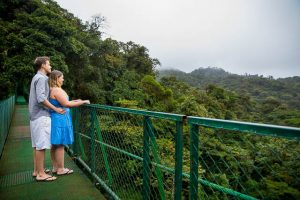 Couple posing on a hanging bride at the Selvatura Park in Monteverde, Costa Rica.