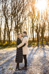 Engaged couple embracing at Devil's Dyke, Sussex