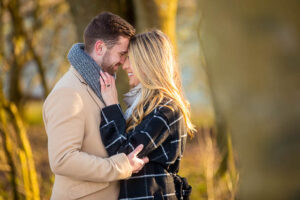 Engaged couple embracing at Devil's Dyke, Sussex