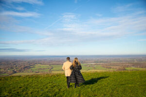 Engaged couple walking together at Devil's Dyke
