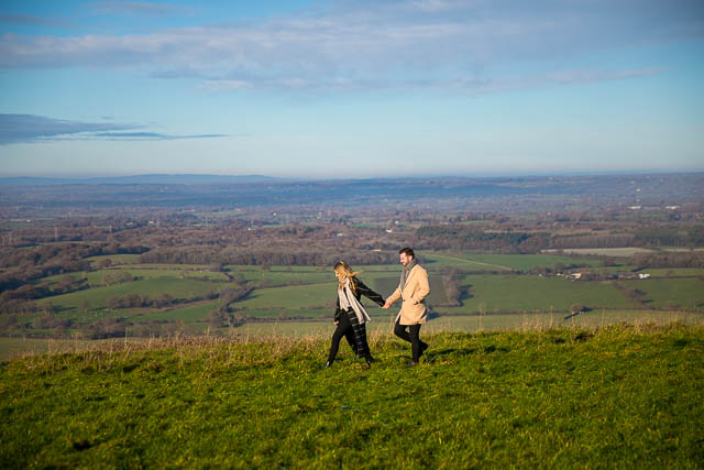 Engaged couple walking together at Devil's Dyke