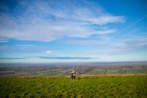 Couple embracing each other with Devil's Dyke as the backdrop