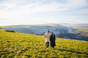 Engaged couple walking together at Devil's Dyke, Sussex, England